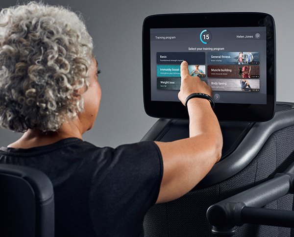 Exerciser selects EGYM training programs